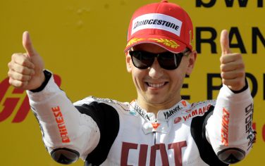 Spanish rider Jorge Lorenzo celebrates with a thumbs up on the podium after wining the Moto GP race of the Portugal Grand Prix  in Estoril, on October 31, 2010. Italians Valentino Rossi and Andrea Dovizioso finished in second and third position. AFP PHOTO/ MIGUEL RIOPA (Photo credit should read MIGUEL RIOPA/AFP/Getty Images)