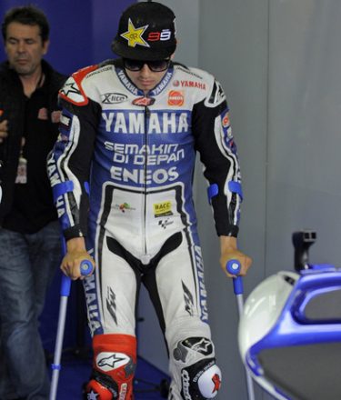 Spain´s Jorge Lorenzo of Yamaha Factory Racing team walks on crutches prior the second training session of the MotoGP of the Grand Prix of Germany at the Sachsenring Circuit on July 6, 2012 in Hohenstein-Ernstthal, eastern Germany.  AFP PHOTO / ROBERT MICHAEL        (Photo credit should read ROBERT MICHAEL/AFP/GettyImages)
