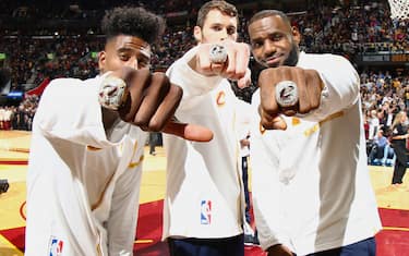 CLEVELAND, OH - OCTOBER 25:  Kevin Love #0, Iman Shumpert #4, and LeBron James #23 of the Cleveland Cavaliers show off their rings during the NBA Championship ring ceremony prior to the game of the Cleveland Cavaliers against the New York Knicks on October 25, 2016 at at Quicken Loans Arena in Cleveland, Ohio. NOTE TO USER: User expressly acknowledges and agrees that, by downloading and/or using this Photograph, user is consenting to the terms and conditions of the Getty Images License Agreement. Mandatory Copyright Notice: Copyright 2016 NBAE (Photo by Nathaniel S. Butler/NBAE via Getty Images)