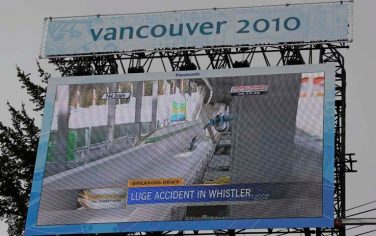 A large video screen in the finish area of the Alpine skiing venue shows the crash of Nodar Kumaritashvili of Georgia during men's singles luge training lat the Vancouver 2010 Olympics in Whistler, British Columbia, Canada, Friday, Feb. 12, 2010. Both Men's and Women's training was cancelled on Friday due to poor weather conditions. (AP Photo/Gero Breloer)