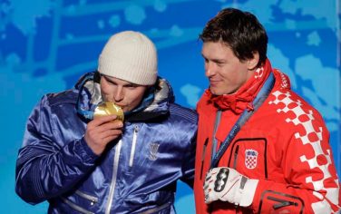 Italy's Giuliano Razzoli, left, celebrates his gold medal with silver medallist Ivica Kostelic of Croatia during the ceremony for the men's slalom of the Vancouver 2010 Olympics in Whistler, British Columbia, Saturday, Feb. 27, 2010. (AP Photo/Jin-man Lee)
