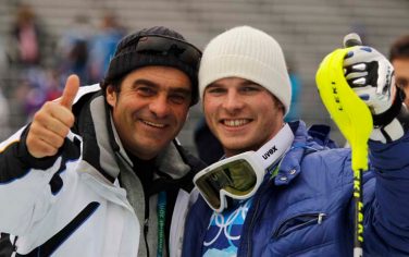 Italian ski legend Alberto Tomba, left, gives the thumb-up sign as he stands in the mixed zone with Italy's Giuliano Razzoli who won the gold medal in the Men's slalom, at the Vancouver 2010 Olympics in Whistler, British Columbia, Saturday, Feb. 27, 2010. (AP Photo/Marco Trovati)