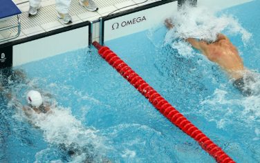 BEIJING - AUGUST 16:  (L-R) Milorad Cavic of Serbia and Michael Phelps of the United States reach for the wall in the Men's 100m Butterfly Final held at the National Aquatics Centre during Day 8 of the Beijing 2008 Olympic Games on August 16, 2008 in Beijing, China.  (Photo by Nick Laham/Getty Images)