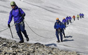 French hooker Benjamin Kayser (L) and teammates walk down the Grande Motte glacier during the French rugby union team's training camp in Tignes, southeastern France, on July 22, 2015 ahead of the 2015 Rugby World Cup. AFP PHOTO / LOIC VENANCE        (Photo credit should read LOIC VENANCE/AFP/Getty Images)