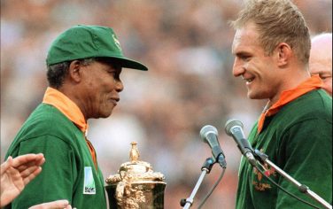 South Africa's president Nelson Mandela congratulates South Africa's rugby team captain François Pienaar before handing him the Webb Ellis Cup after the 1995 Rugby World Cup final match South Africa vs New Zealand at Ellis Park Stadium in Johannesburg on June 24, 1995. AFP PHOTO/JEAN-PIERRE MULLER        (Photo credit should read JEAN-PIERRE MULLER/AFP/Getty Images)