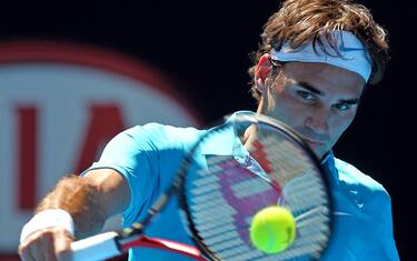 Roger Federer of Switzerland returns to  Russia's Igor Andreev during their Men's singles first round match at the Australian Open tennis championship in Melbourne, Australia, Tuesday Jan. 19, 2010.    (AP Photo/Mark Baker)