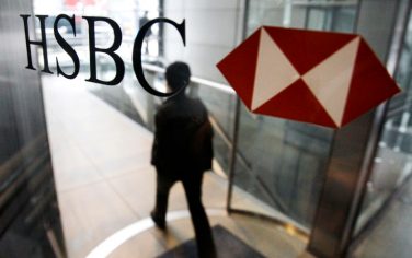 A man walks past a logo of HSBC Holdings PLC at the bank's headquarter in Hong Kong Monday, March 2, 2009.  HSBC PLC plans to scale back its consumer lending operations in the United States and to close hundreds of branches there, British and U.S. newspapers reported Sunday. The Financial Times and the Wall Street Journal said HSBC will announce the plans on Monday as it discloses its 2008 results and confirms a plan to raise 12 billion pounds ($17 billion) in a new rights issue.(AP Photo/Vincent Yu)
