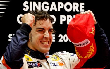 FILE - In this Sunday Sept. 28 2008 file photo, Renault Formula One auto racing driver Fernando Alonso of Spain reacts after winning the Singapore Formula One Grand Prix on the Marina Bay City Circuit in Singapore. On Wednesday, Sept. 16, 2009, Renault said managing director Flavio Briatore and engineering chief executive Pat Symonds are leaving the Formula One team, and that it will not dispute charges that Nelson Piquet Jr. was ordered to crash in a race. Renault has been summoned to Paris by governing body FIA to answer a charge that Piquet Jr. was told to crash at last year's Singapore Grand Prix to improve teammate Fernando Alonso's chances of victory. The Spaniard won the race. Renault said it will not dispute the recent allegations made by the FIA concerning the 2008 Singapore Grand Prix. (AP Photo/Vincent Thian, File)