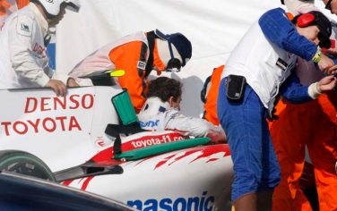 Germany's Formula One driver Timo Glock is helped to get off from the pit of his Toyota after a crash during qualifying for Sunday's Japanese Grand Prix at the Suzuka Circuit in Suzuka, central Japan, Saturday, Oct. 3, 2009.  (AP Photo/Toru Takahashi)