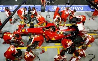 The Ferrari Formula One team practice their pit stops outside their team garage at the Marina Bay City Circuit in Singapore, Thursday, Sept 24, 2009. Singapore will host the season's 14th Formula One Grand Prix on Sunday Sept. 27. (AP Photo/Mark Baker)