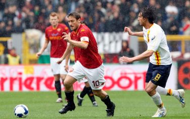 AS Roma forward Francesco Totti, left, and Lecce midfielder Gianni Munari, right, compete for the ball during a Serie A soccer match between AS Roma and Lecce at Rome's Olympic stadium, Sunday, April 19, 2009. (AP Photo/Riccardo De Luca)