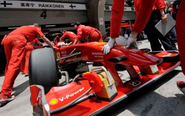 Mechanics for Ferrari Formula One driver Kimi Raikkonen of Finland push his car back into his team garage during the first practice session for the Chinese Formula One Grand Prix at the Shanghai International Circuit in Shanghai, China, Friday April 17, 2009. The Chinese Grand Prix will be held at the circuit on Sunday April 19. (AP Photo/Andy Wong)
