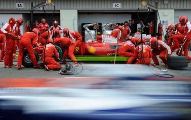 Technicians work on the Ferrari Formula One car of driver Kimi Raikkonen of Finland it the pits during the qualifying session ahead of the British Formula One Grand Prix at the Silverstone racetrack, in Silverstone, England, Saturday June 20, 2009. (AP Photo/Nigel Roddis, Pool)