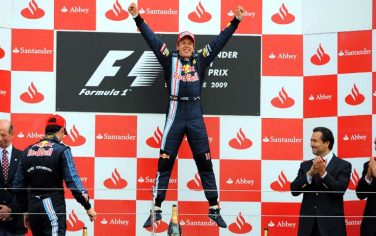 epa01768431 German Formula One driver Sebastian Vettel of Red Bull celebrates with a jump on the podium after he won the Grand Prix of Great Britain at the Silverstone race track in Northamptonshire, Great Britain, 21 June 2009.  EPA/GERRY PENNY