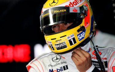 McLaren Mercedes Formula One driver Lewis Hamilton of Britain, reacts as he adjusts his helmet during second practice session in Sepang racetrack, outside Kuala Lumpur, Malaysia, Friday, April 3, 2009. The 2009 Malaysian  Formula 1 Grand Prix which will be held here Sunday, April 5, 2009. (AP Photo/Eugene Hoshiko)