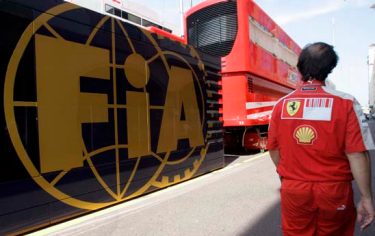 An unidentified Ferrari technician passes near by the FIA mobil home ahead of the Monaco Formula One Grand Prix at the Monaco racetrack, Wednesday May 20, 2009. A French court on Wednesday dismissed Ferrari's bid to stop Formula One from instituting a budget cap next season. Ferrari sought a court injunction against governing body FIA's plans to introduce a voluntary $60 million cap for racing teams from 2010, but the appeal was rejected by Judge Jacques Gondrand de Robert. Ferrari, Renault, Toyota, Red Bull and Toro Rosso have threatened to pull out of next year's championship if the cap isn't overturned. (AP Photo/Antonio Calanni)